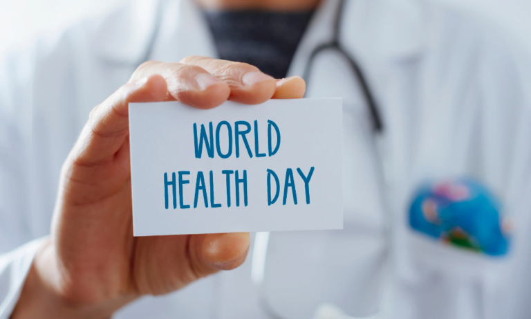 Medical professional holding a smal sign that says world health day
