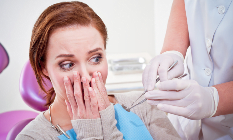 Women hold hands to her face at dentist practice