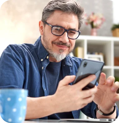bearded man smiling at phone